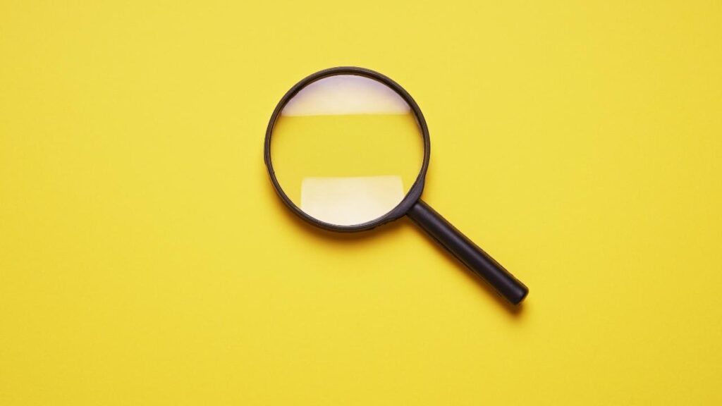 Magnifying Glass on a Yellow Background